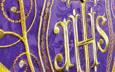 Fiołowy ornament liturgiczny z motywem IHS